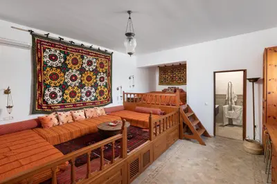a living room with a couch and a rug on the wall at Villa Venetoklis in Líndos