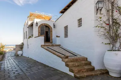 a white building with stairs and a door at Villa Venetoklis in Líndos