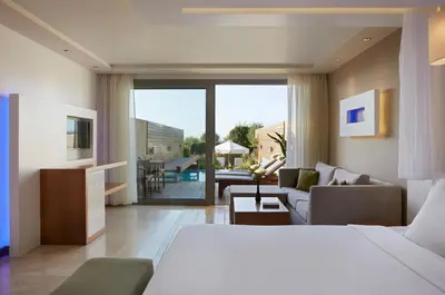 a hotel room with a bed and a living room at Amus Hotel & Spa in Ixia