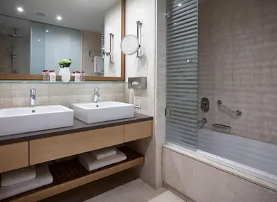 a bathroom with two sinks and a shower at Amus Hotel & Spa in Ixia