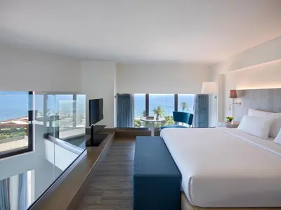 a hotel room with a bed and a view of the ocean at Amus Hotel & Spa in Ixia