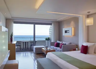 a hotel room with a bed and a living room at Amus Hotel & Spa in Ixia