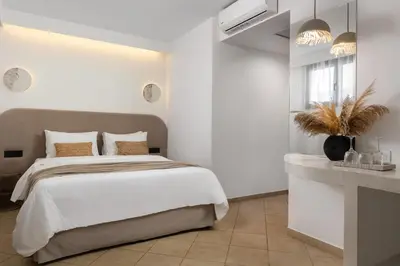 a white bedroom with a bed and a table at Diana Art Boutique Hotel in Rhodes Town