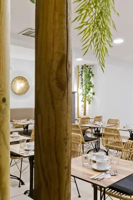 a restaurant with tables and chairs and a tree at Diana Art Boutique Hotel in Rhodes Town