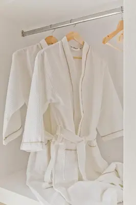 a group of white shirts hanging on a rack at Diana Art Boutique Hotel in Rhodes Town