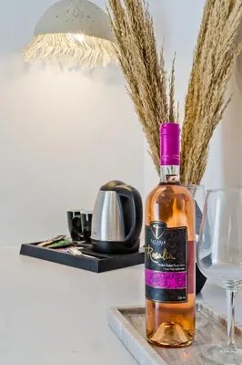 a bottle of whisky sitting next to a wine glass at Diana Art Boutique Hotel in Rhodes Town