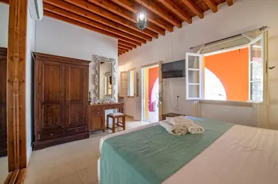 a bedroom with a bed with towels on it at Saint Artemios Boutique Hotel in Rhodes Town