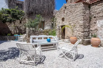 a group of chairs and a table in front of a building at Saint Artemios Boutique Hotel in Rhodes Town