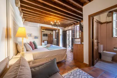 a bedroom with a large bed and a bathroom at Saint Artemios Boutique Hotel in Rhodes Town