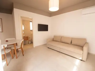 a living room with a couch and a table at STARI in Kattavía