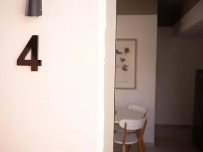a number four on a wall next to a table at STARI in Kattavía