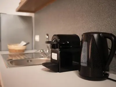 a black toaster sitting on a counter next to a sink at STARI in Kattavía