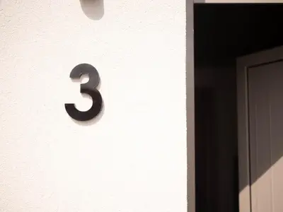 a number on the side of a building at STARI in Kattavía