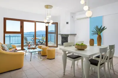 a living room with a white table and chairs at Artoria Apartment 2 First Floor in Haraki