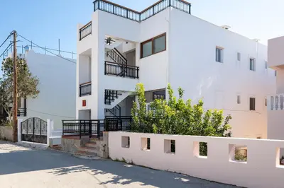 a white apartment building with a balcony at Artoria Apartment 2 First Floor in Haraki