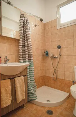a bathroom with a shower and a sink at Basiliki's Apartments in Archangelos