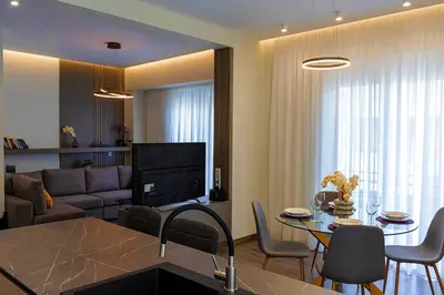 a living room with a couch and a table with chairs at Mini City Escape in Rhodes Town