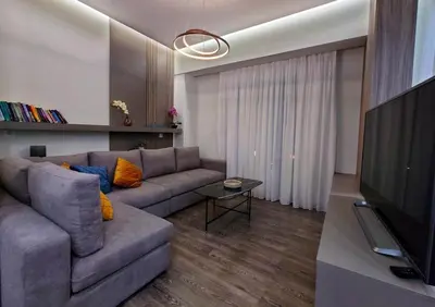 a living room with a couch and a flat screen tv at Mini City Escape in Rhodes Town