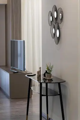 a living room with a table and a tv at Mini City Escape in Rhodes Town
