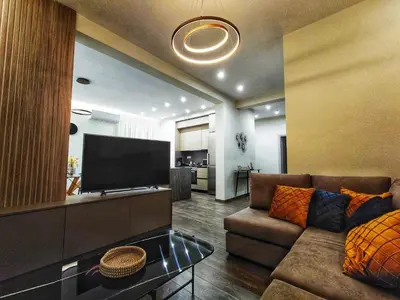 a living room with a couch and a flat screen tv at Mini City Escape in Rhodes Town