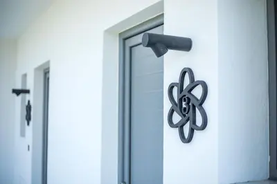 a metal sign on the side of a building at Anemone Premium Suites Faliraki in Faliraki
