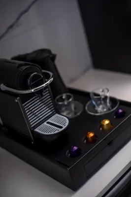 a black tray with glasses and wine glasses at Anemone Premium Suites Faliraki in Faliraki