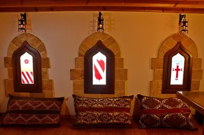 a room with three windows with crosses in them at The three story old town house in Rhodes Town