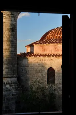 a brick building with a red tile roof at The three story old town house in Rhodes Town