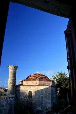 a building with a tower and a dome on top at The three story old town house in Rhodes Town