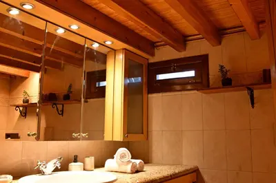 a bathroom with a sink and a mirror at The three story old town house in Rhodes Town