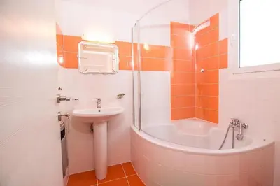a bathroom with a sink and a toilet and a tub at Villa Regina - Luxury and Comfort in Lachania