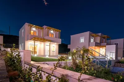a large white house at night with lights at Villa Regina - Luxury and Comfort in Lachania