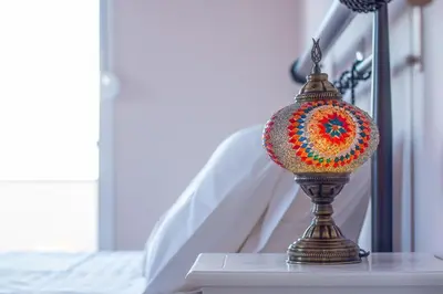 a small lamp sitting on a table next to a bed at Villa Regina - Double Pool Paradise in Lachania