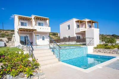 a villa with a swimming pool and a house at Regina Villa - Family Dream with double pool in Lachania