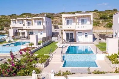 an aerial view of a house with two swimming pools at Regina Villa - Family Dream with double pool in Lachania