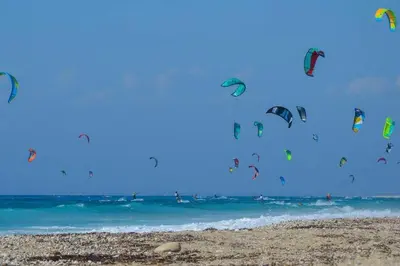 a bunch of kites flying in the sky over the ocean at Evaggelia's Private House in Fanes Rhodes in Phanaes