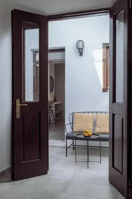 an open door leading into a living room with a couch at Kilistra Lindian Living in Líndos