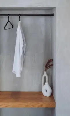 a shelf with a white vase and a towel at Kilistra Lindian Living in Líndos