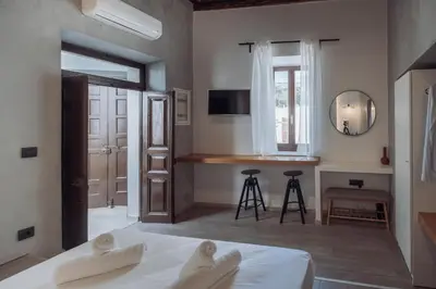 a bedroom with a bed and a kitchen with a counter at Kilistra Lindian Living in Líndos