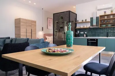 a table with a vase and a bowl of candy at Casa d'oro 56 Living in Paradisi Rhodes in Paradeísion