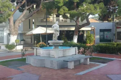 a statue of a man sitting on top of a fountain at Casa d'oro 56 Living in Paradisi Rhodes in Paradeísion