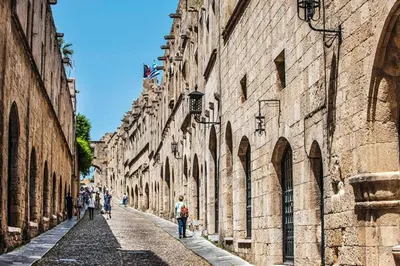 a group of people walking down an alley between buildings at Casa d'oro 56 Living in Paradisi Rhodes in Paradeísion