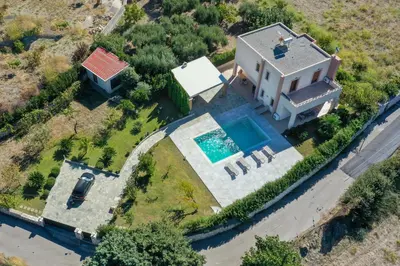 an aerial view of a house with a swimming pool at Vlasis' Eden Villa - Islander's Home Collection in Sálakos