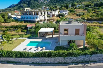 an aerial view of a villa with a swimming pool at Vlasis' Eden Villa - Islander's Home Collection in Sálakos