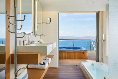 a bathroom with a tub and a sink and a bath tub at Lindos Blu Luxury Hotel-Adults only in Líndos