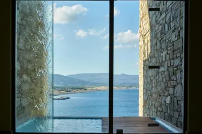 a large glass window with a view of the water at Lindos Blu Luxury Hotel-Adults only in Líndos