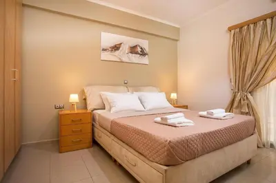 a bedroom with a bed with two towels on it at Anita Luxury Apartment in Rhodes Town