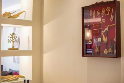 a clock on a wall with a bunch of jewelry at Anita Luxury Apartment in Rhodes Town