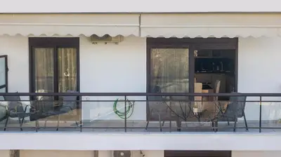 a balcony with two chairs and a table at Anita Luxury Apartment in Rhodes Town