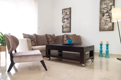 a living room with a couch and a table and a chair at Naelia in Pastida